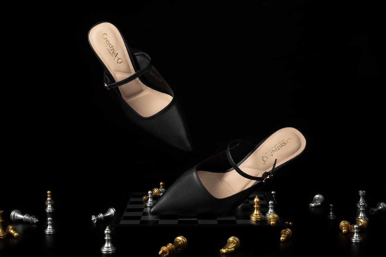 creative-03 Stylish black heels with a chessboard theme, ideal for fashion concepts.